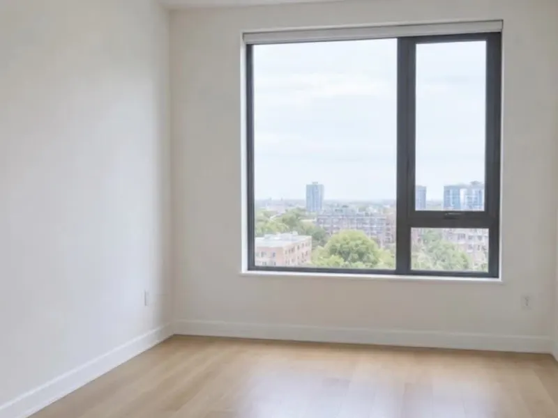 Example of an empty room with bare walls and a wood floor, before plans, build-out and furnishing